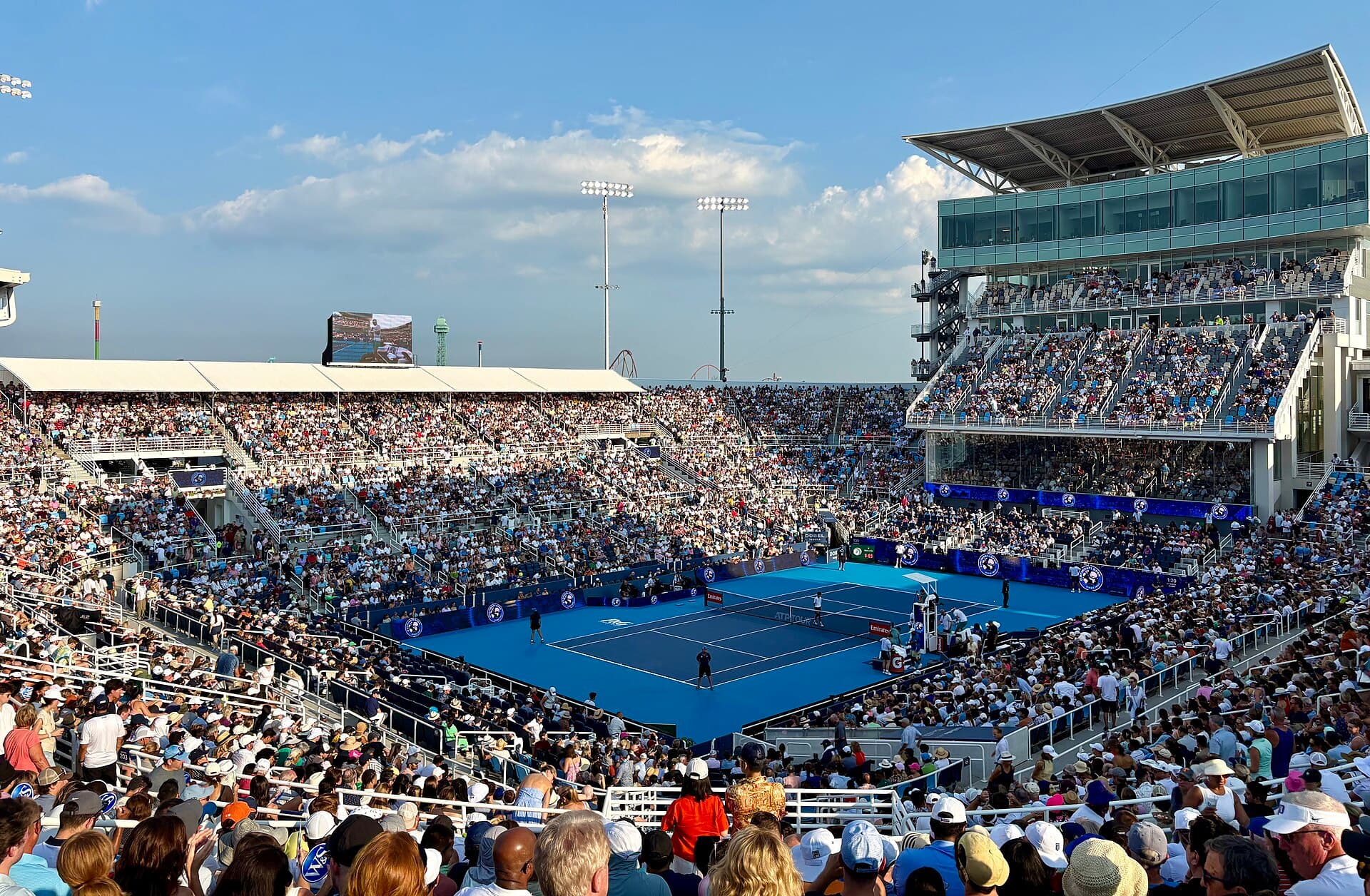 Blue professional stadium court surrounded by full stands in Cincinnati.
