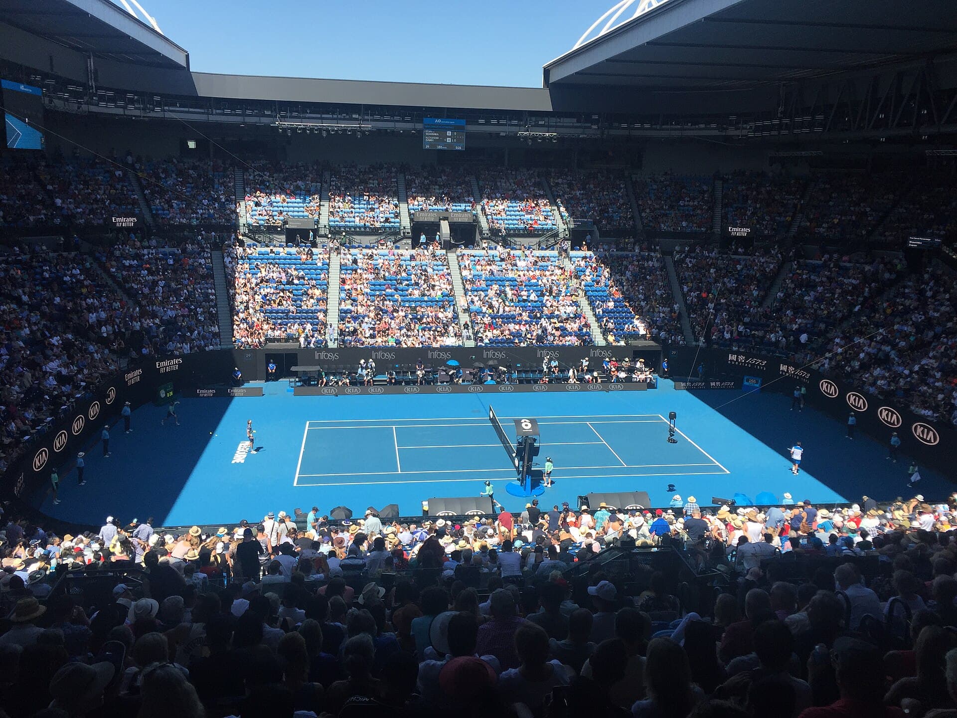 Blue championship court surrounded by stadium stands at Rod Laver Arena.